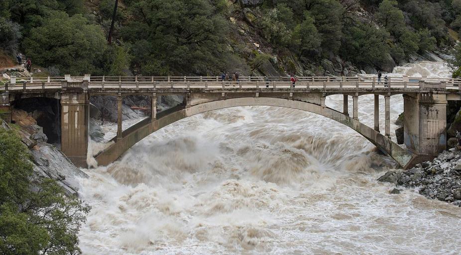 The South Yuba River at Highway 49 during 2017 floods that would ultimately cause 5 deaths and more than $1.5 billion in damage. A historic megaflood, which may become more frequent with climate change, would be far more catastrophic. (Kelly M. Grow, California Department of Water Resources.)