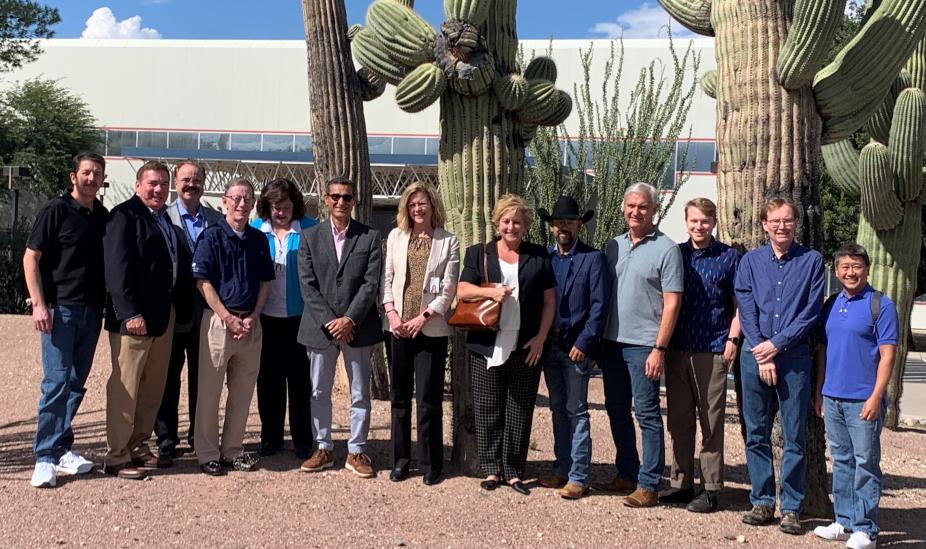 Group photo of HPCD and IBM staff members outdoors in Tucson with cacti in the background.