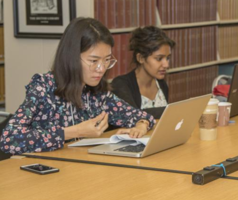 Two women studying in library